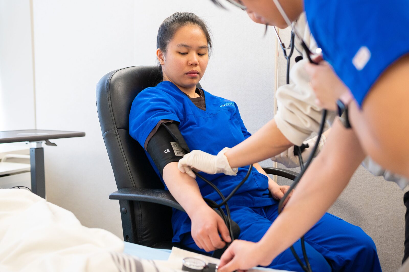 A healthcare worker checking a patient's blood pressure