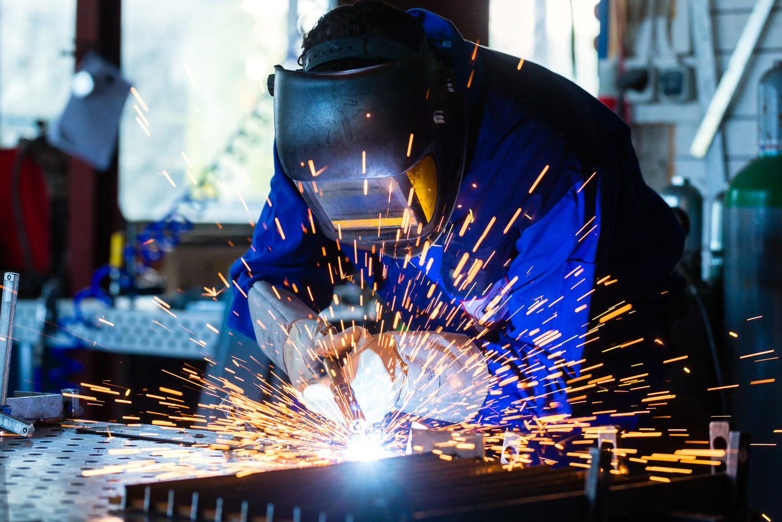 A welder joining metal with sparks flying